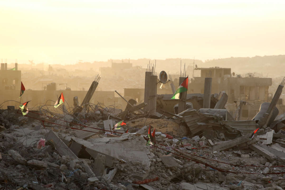 Palestinian flags flutter on top of rubble in Gaza City on October 12, 2025.
