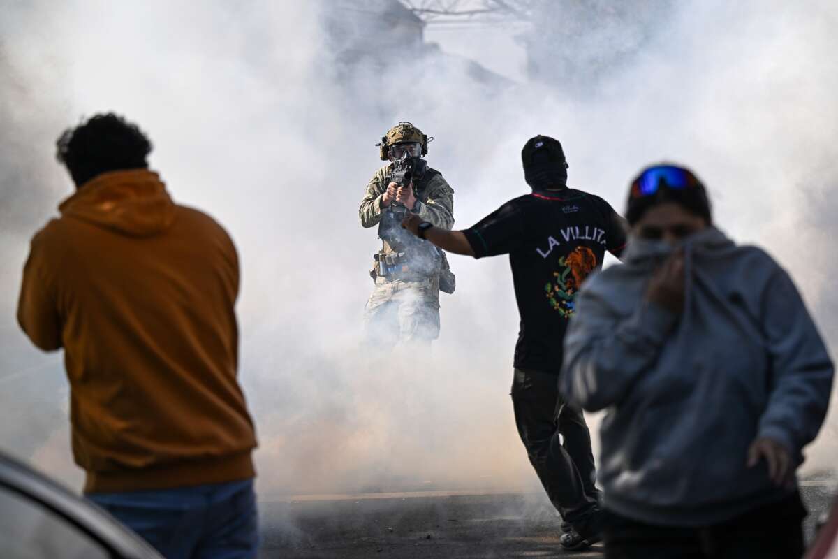 Residents and protesters clash with federal agents in the East Side neighborhood of Chicago, Illinois, on October 14, 2025. It was not immediately clear why federal agents were in the area but people on social media reported Immigration and Customs Enforcement agents arrested an individual and caused a car accident.