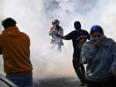 Residents and protesters clash with federal agents in the East Side neighborhood of Chicago, Illinois, on October 14, 2025. It was not immediately clear why federal agents were in the area but people on social media reported Immigration and Customs Enforcement agents arrested an individual and caused a car accident.