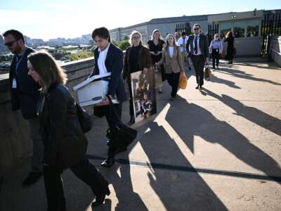 Reporters carry their belongings from the Pentagon in Washington, D.C., on October 15, 2025 after U.S. and international news outlets including The New York Times, AP, AFP and Fox News declined to sign new restrictive Pentagon media rules, and were stripped of their press access credentials.