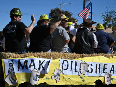 People ride a float during the Oildorado Grand Parade, themed "Make Oil Great Again," on October 18, 2025 in Taft, California, a town of about 7,000 residents built atop the Midway-Sunset Oil Field.