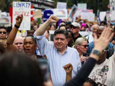 Illinois Governor JB Pritzker joins the demonstrators during the second "No Kings" protest on October 18, 2025, in Chicago, Illinois.