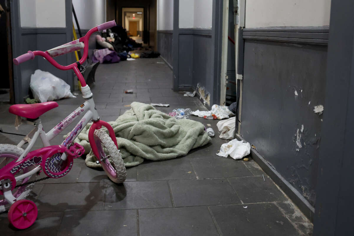 A pink bicycle, diapers, and clothing are scattered about the second floor hallway following a raid by U.S. Immigration and Customs Enforcement agents the previous week in Chicago, Illinois, on October 6, 2025.