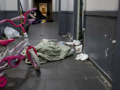A pink bicycle, diapers, and clothing are scattered about the second floor hallway following a raid by U.S. Immigration and Customs Enforcement agents the previous week in Chicago, Illinois, on October 6, 2025.