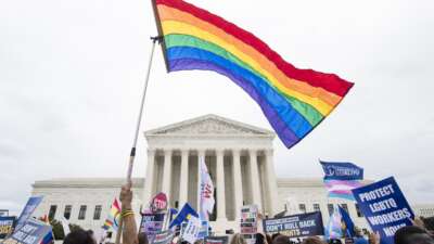 Protesters rally in front of the Supreme Court as it hears arguments on whether gay and transgender people are covered by a federal law barring employment discrimination on the basis of sex on Tuesday, Oct. 8, 2019.