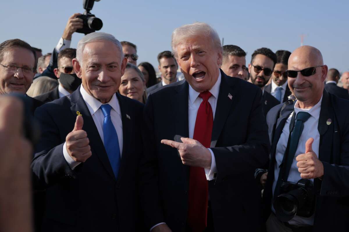 U.S. President Donald Trump speaks to Israeli Prime Minister Benjamin Netanyahu at Ben Gurion International Airport before boarding his plane to Sharm El-Sheikh, on October 13, 2025 in Tel Aviv, Israel.