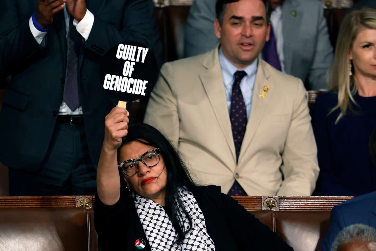 Rep. Rashida Tlaib (D-Michigan) holds a sign that reads "Guilty of Genocide" as Israeli Prime Minister Benjamin Netanyahu addresses a joint meeting of Congress in the chamber of the House of Representatives at the U.S. Capitol on July 24, 2024 in Washington, D.C.