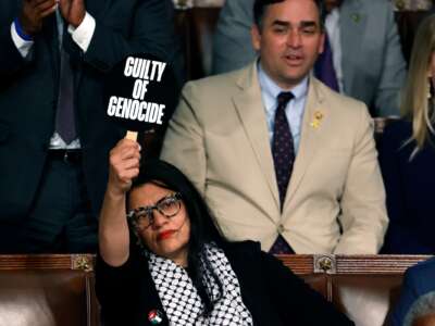 Rep. Rashida Tlaib (D-Michigan) holds a sign that reads "Guilty of Genocide" as Israeli Prime Minister Benjamin Netanyahu addresses a joint meeting of Congress in the chamber of the House of Representatives at the U.S. Capitol on July 24, 2024 in Washington, D.C.