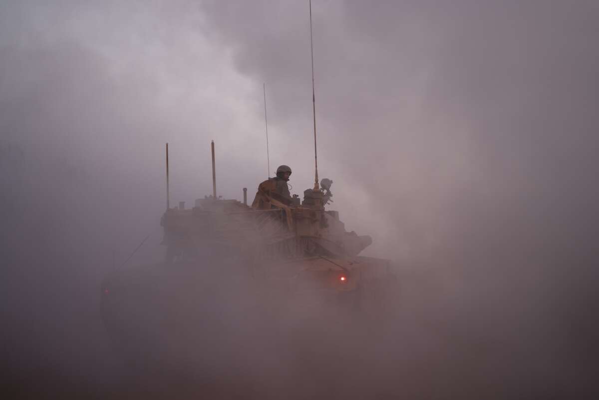 An Israeli soldier rides in the army Merkava main battle tank at a position in northern Israel along the border with southern Lebanon on November 6, 2025.