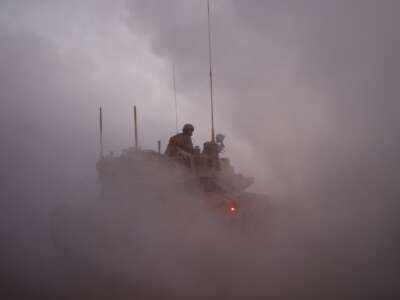 An Israeli soldier rides in the army Merkava main battle tank at a position in northern Israel along the border with southern Lebanon on November 6, 2025.