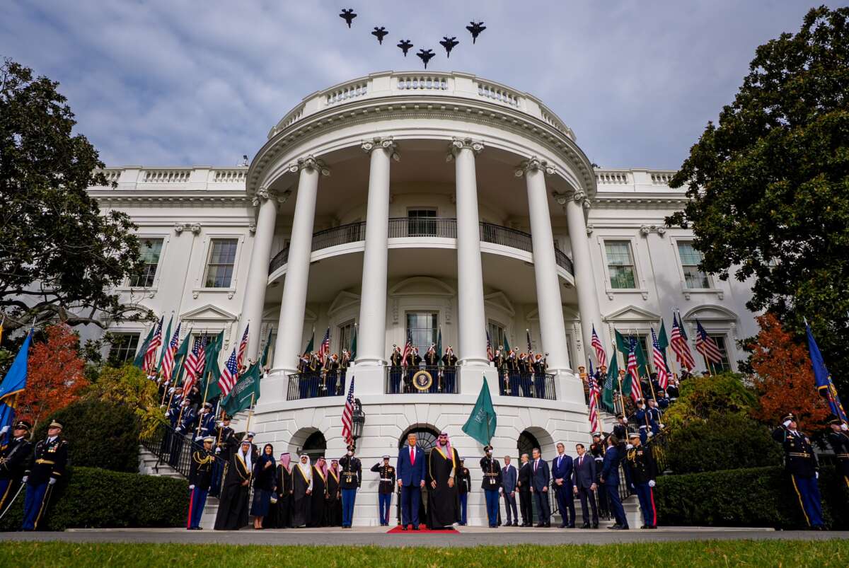 U.S. President Donald Trump stands with Crown Prince and Prime Minister Mohammed bin Salman of Saudi Arabia as F-35 and F-15 U.S. military jets perform a flyover during an arrival ceremony at the White House on November 18, 2025 in Washington, D.C.