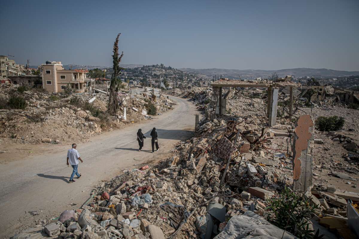 Visiting residents walk down a street in the mostly destroyed Lebanese village of Ayta al-Shaab November 7, 2025.
