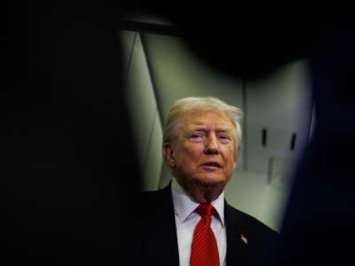 U.S. President Donald Trump speaks to reporters aboard Air Force One en route to the White House on November 2, 2025 after taking off from Palm Beach International Airport in West Palm Beach, Florida.