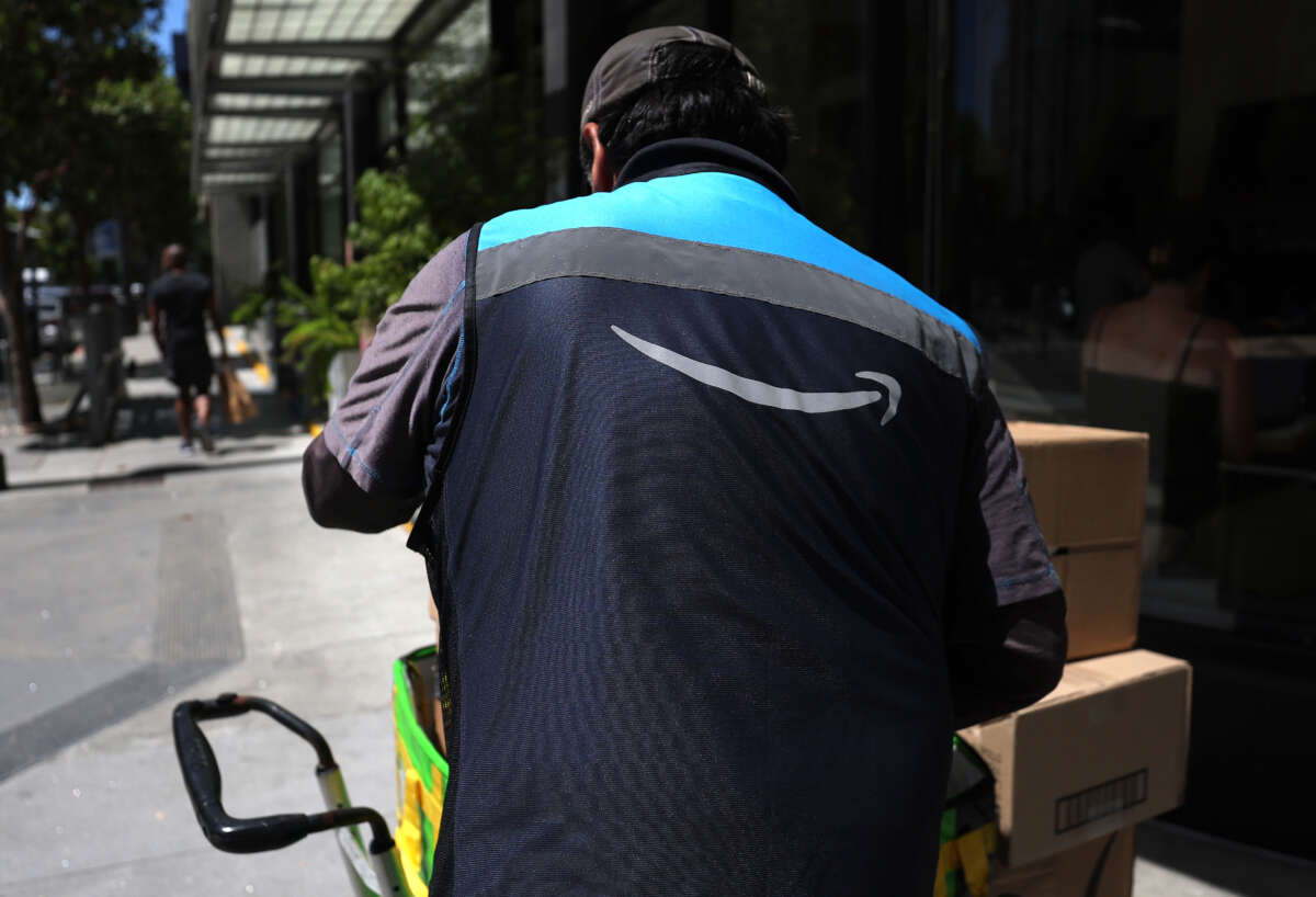 An Amazon delivery driver loads a cart with packages on July 16, 2024, in San Francisco, California.