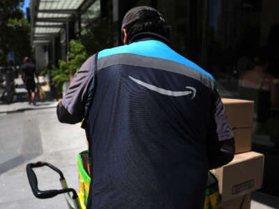 An Amazon delivery driver loads a cart with packages on July 16, 2024, in San Francisco, California.