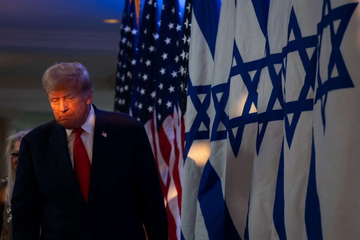 Donald Trump walks on stage at a fighting antisemitism event with Miriam Adelson at the Trump National Golf Club Bedminster on August 15, 2024, in Bedminster, New Jersey.