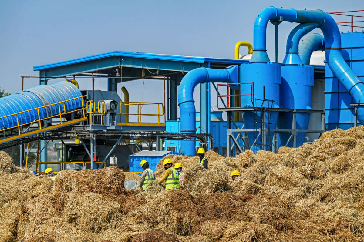 Employees assemble bales of rice stubble at a compressed biogas (CBG) production facility in Barsana, in India's northern state of Uttar Pradesh, on October 17, 2024.