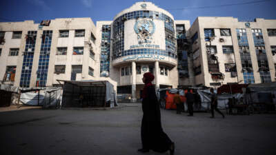 Displaced Palestinians sit by their makeshift tents outside the UNRWA-run clinic at al-Shati refugee camp in Gaza City, Palestine, on April 28, 2025.