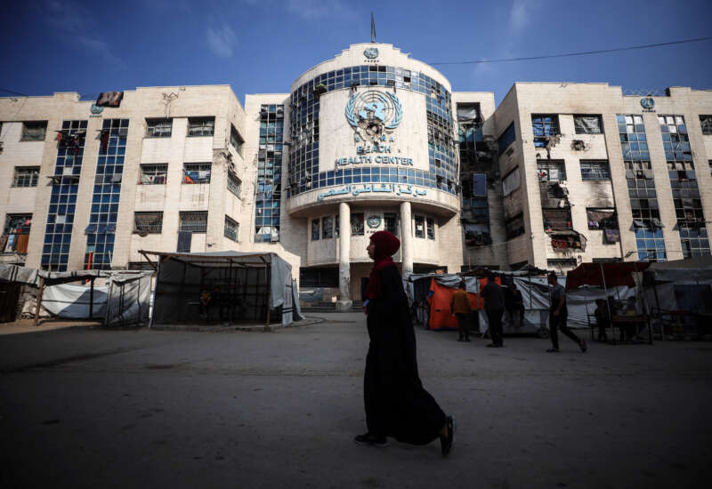 Displaced Palestinians sit by their makeshift tents outside the UNRWA-run clinic at al-Shati refugee camp in Gaza City, Palestine, on April 28, 2025.