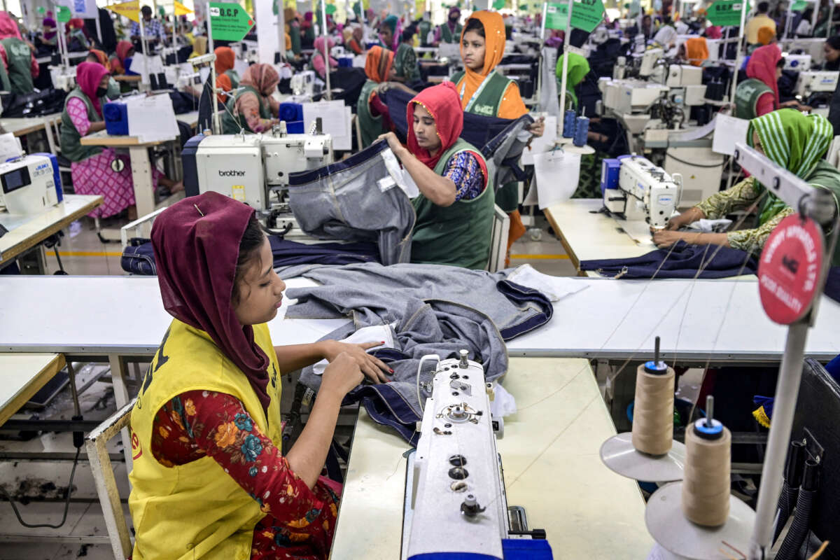 Garment workers tailor clothes at their sewing stations in a garment factory in Tongi, on the outskirts of Dhaka, Bandladesh, on July 6, 2025.