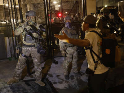 ICE Police push back demonstrators outside the back entrance of the Edward R. Roybal Federal Building on Labor Day, September 1, 2025, in Los Angeles, California.