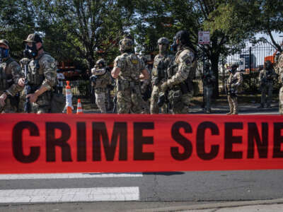Federal law enforcement agents are confronted by community members and activists for shooting a woman in the Brighton Park neighborhood on October 4, 2025, in Broadview, Illinois.