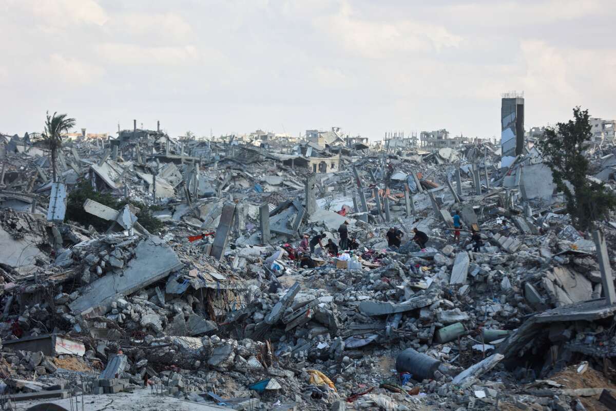 Palestinians search the rubble of buildings amid widespread destruction due to Israeli bombardment in Khan Younis in the southern Gaza Strip, on October 12, 2025.