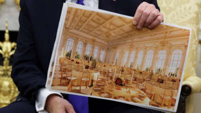 U.S. President Donald Trump displays a rendering of his proposed $250 million White House ballroom as he meets with NATO Secretary General Mark Rutte in the Oval Office of the White House on October 22, 2025, in Washington, D.C.