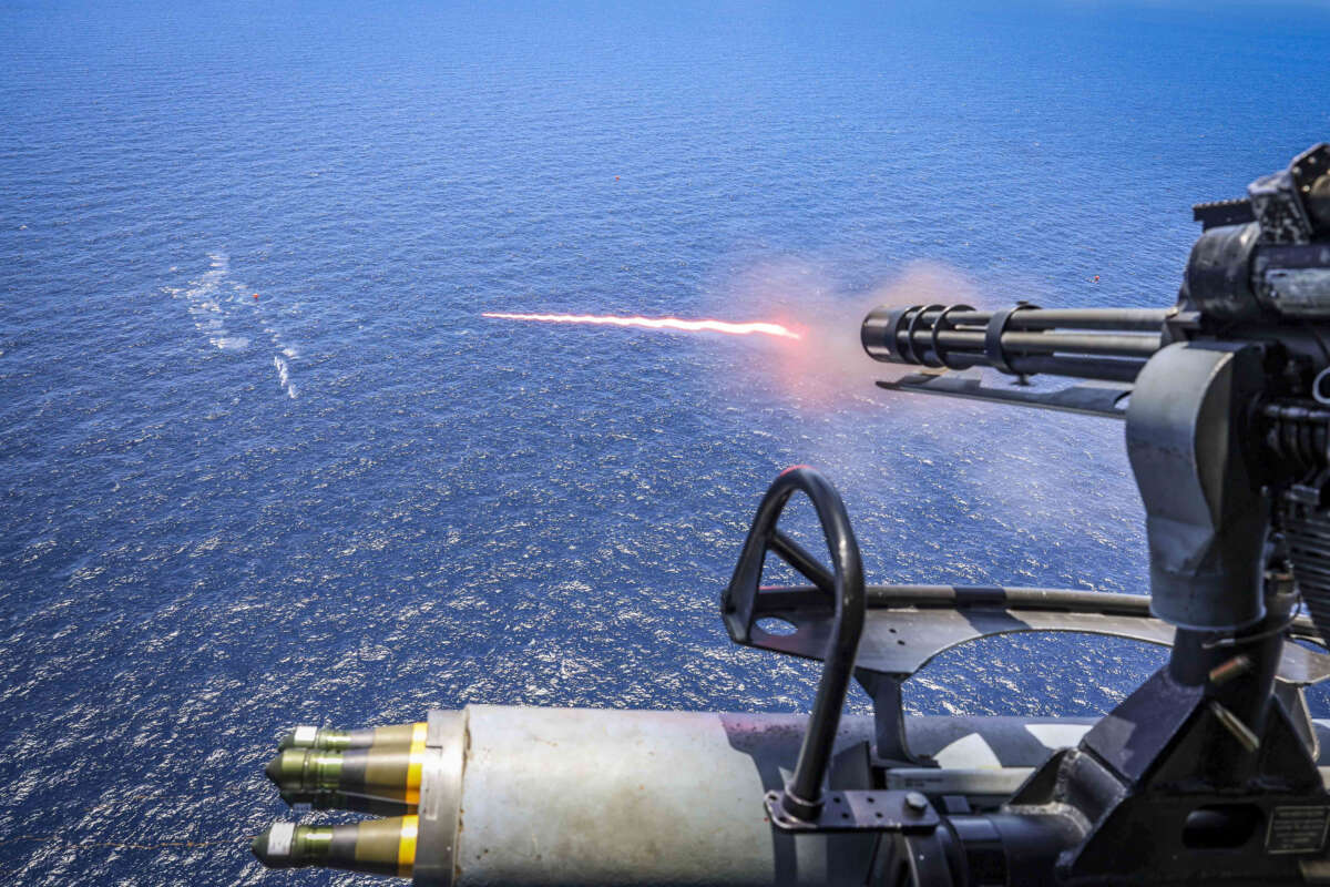 In this handout provided by the U.S. Navy, A UH-1Y Venom, assigned to Marine Medium Tiltrotor Squadron (VMM) 263 (Reinforced), fires a GAU-17 Gatling gun during a live-fire exercise on September 22, 2025, in the Caribbean sea.