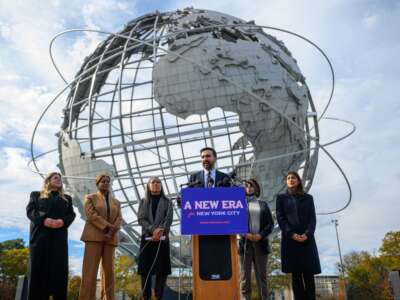 Mayor-elect of New York City Zohran Mamdani stands alongside members of his transition team as he speaks during a press conference at the Unisphere in Flushing Meadows Corona Park on November 5, 2025, in the Queens borough of New York City.