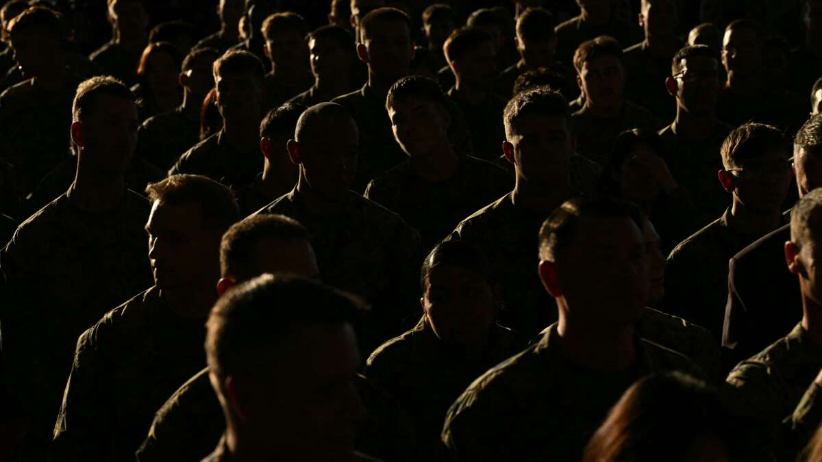 Members of the military listen as First Lady Melania Trump gives remarks during her visit to Marine Corps Air Station New River in Jacksonville, North Carolina, November 19, 2025.