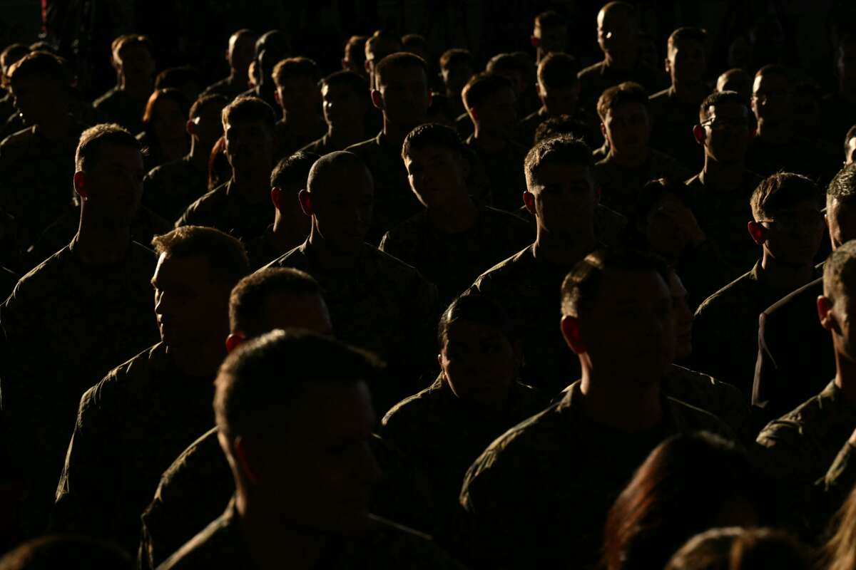 Members of the military listen as First Lady Melania Trump gives remarks during her visit to Marine Corps Air Station New River in Jacksonville, North Carolina, November 19, 2025.