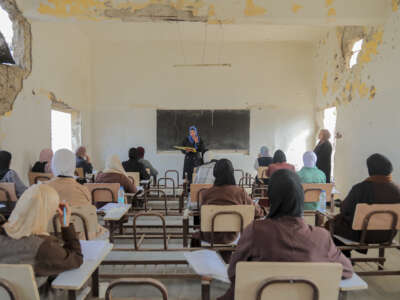 Students take their exam in a damaged classroom at Al-Azhar institutes in Gaza City in the Gaza Strip on November 18, 2025.