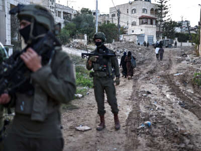Palestinians evacuate their homes during an Israeli army raid on the Jenin refugee camp in the occupied West Bank, Palestine, on November 27, 2025.