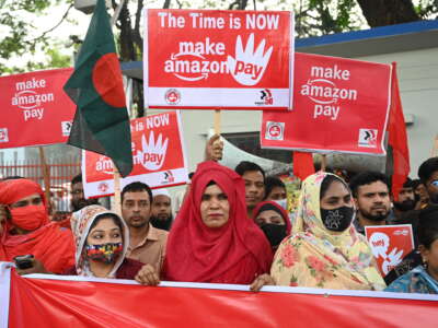 Activists of the Sommilito Garments Sramik Federation (Combined Garments Workers Federation) stage a protest procession against Amazon Company under the title ''Make Amazon Pay,'' demanding that Amazon sign the Accord on Fire and Building Safety, provide a minimum wage of $200 to garment workers, and ensure the safety of workers' lives, in Dhaka, Bangladesh, on November 28, 2025.