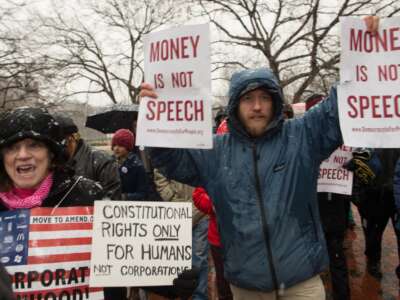 Demonstrators march through Lafayette Park, outside the White House, to the U.S. Chamber of Commerce during a rally against the Supreme Court's decision in Citizens United, which allows private citizens and corporations to make unlimited donations for political campaigns, in Washington, D.C., on January 21, 2015.