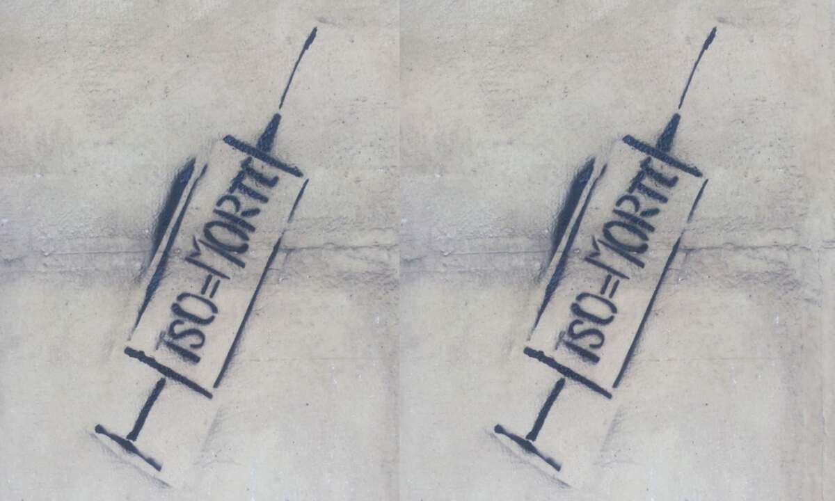 Protest graffiti features a stenciled image of a hypodermic needle and the letters TSO = MORTE, which means “Involuntary treatment = Death” in Italian, in Turin, Italy, on May 23, 2016.