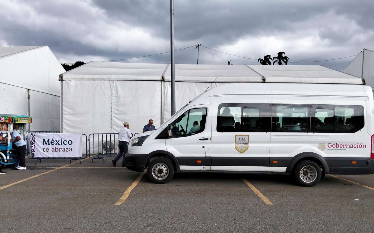 A Gobernación van transporting deportees from the airport arrives at a temporary reception center set up by the Mexican government in a sports stadium parking lot.