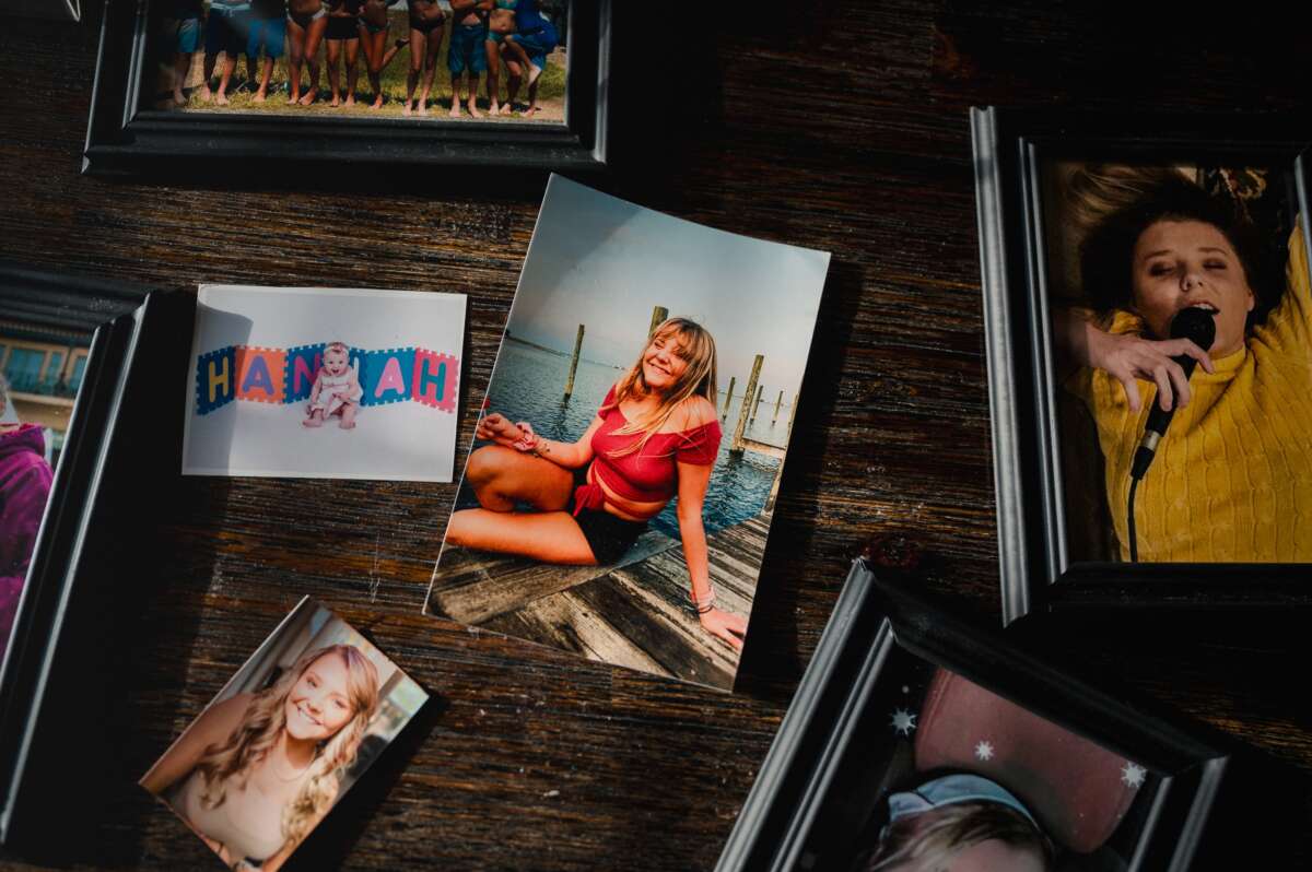 Old photos of Hannah Goetz sit on the dining room table in Portsmouth, Virginia, on April 4, 2025. Hannah Goetz was in fourth grade when doctors figured out that her regular bouts of bronchitis and her struggle to gain weight were caused by cystic fibrosis.
