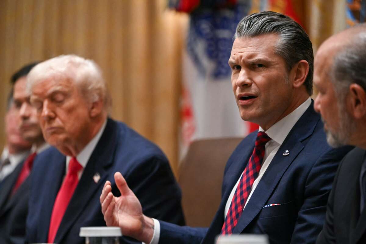 U.S. Secretary of Defense Pete Hegseth (R) speaks alongside President Donald Trump (L) during a Cabinet Meeting in the Cabinet Room of the White House in Washington, D.C. on December 2, 2025.