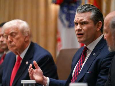 U.S. Secretary of Defense Pete Hegseth (R) speaks alongside President Donald Trump (L) during a Cabinet Meeting in the Cabinet Room of the White House in Washington, D.C. on December 2, 2025.