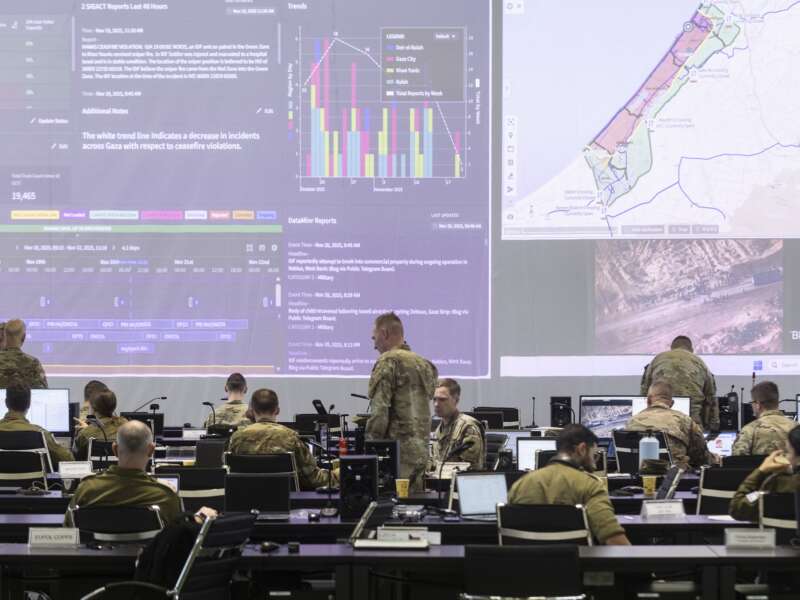 U.S. Army personnel, IDF personnel and others international officials monitor screens displaying maps and imagery of the Gaza Strip during a media tour inside the Civil-Military Coordination Center (CMCC) on November 20, 2025 in Kiryat Gat, Israel.