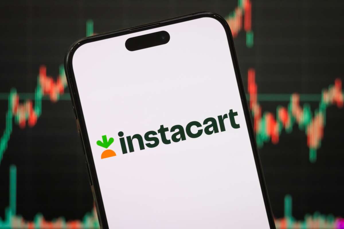 The logo of Maplebear Inc., doing business as Instacart, is displayed on a smartphone screen, with the company’s latest stock market chart visible in the background.