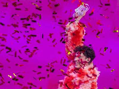Nemo from Switzerland holds up the broken trophy at the award ceremony in the final of the Eurovision Song Contest 2024. Nemo accidentally broke the trophy on stage after winning and was given a replacement trophy.