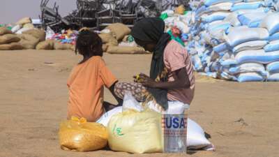 Sudanese girls who fled El-Fasher receive humanitarian aid at the Al-Afad camp for displaced people in the town of Al-Dabba, northern Sudan, on November 25, 2025.