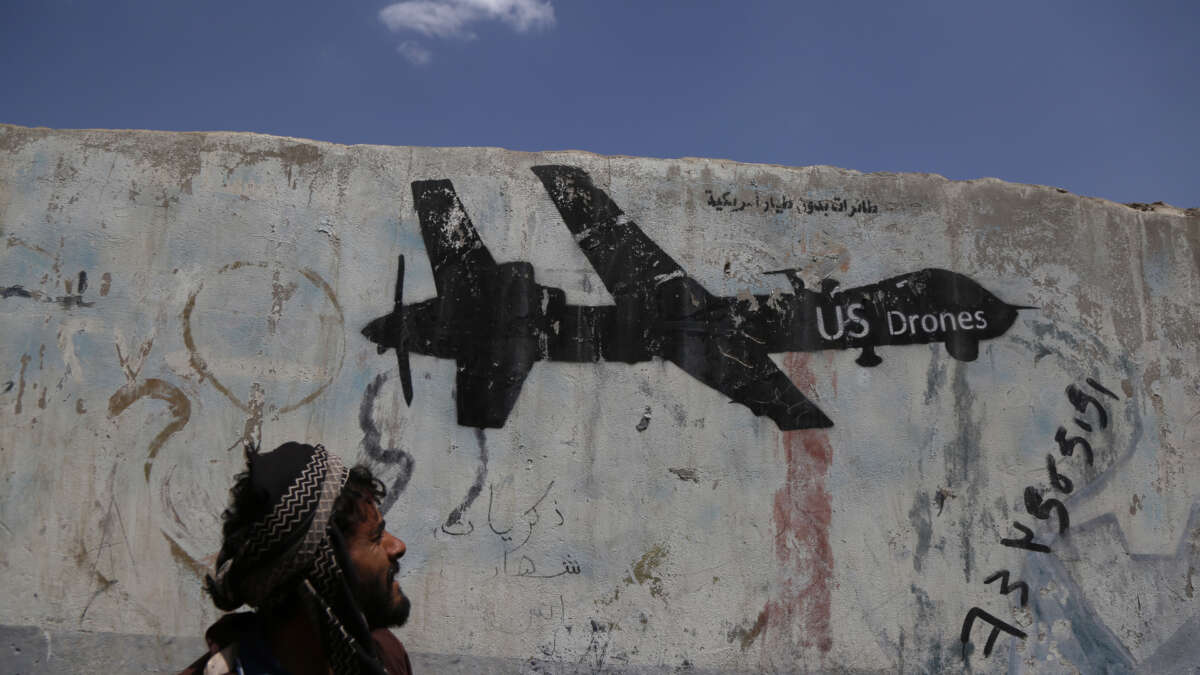 A Yemeni man looks at graffiti protesting against U.S. drone strikes on September 19, 2018, in Sana'a, Yemen.