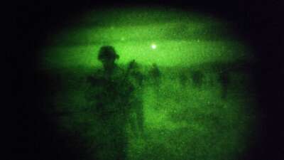 Soldiers of the 4-320th Field Artillery Battalion of the 101st Airborne Division, seen through night vision goggles, on a night patrol December 28, 2008, in Sabari District, Khost Province, Afghanistan.