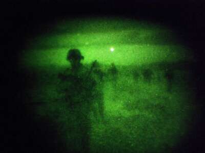 Soldiers of the 4-320th Field Artillery Battalion of the 101st Airborne Division, seen through night vision goggles, on a night patrol December 28, 2008, in Sabari District, Khost Province, Afghanistan.