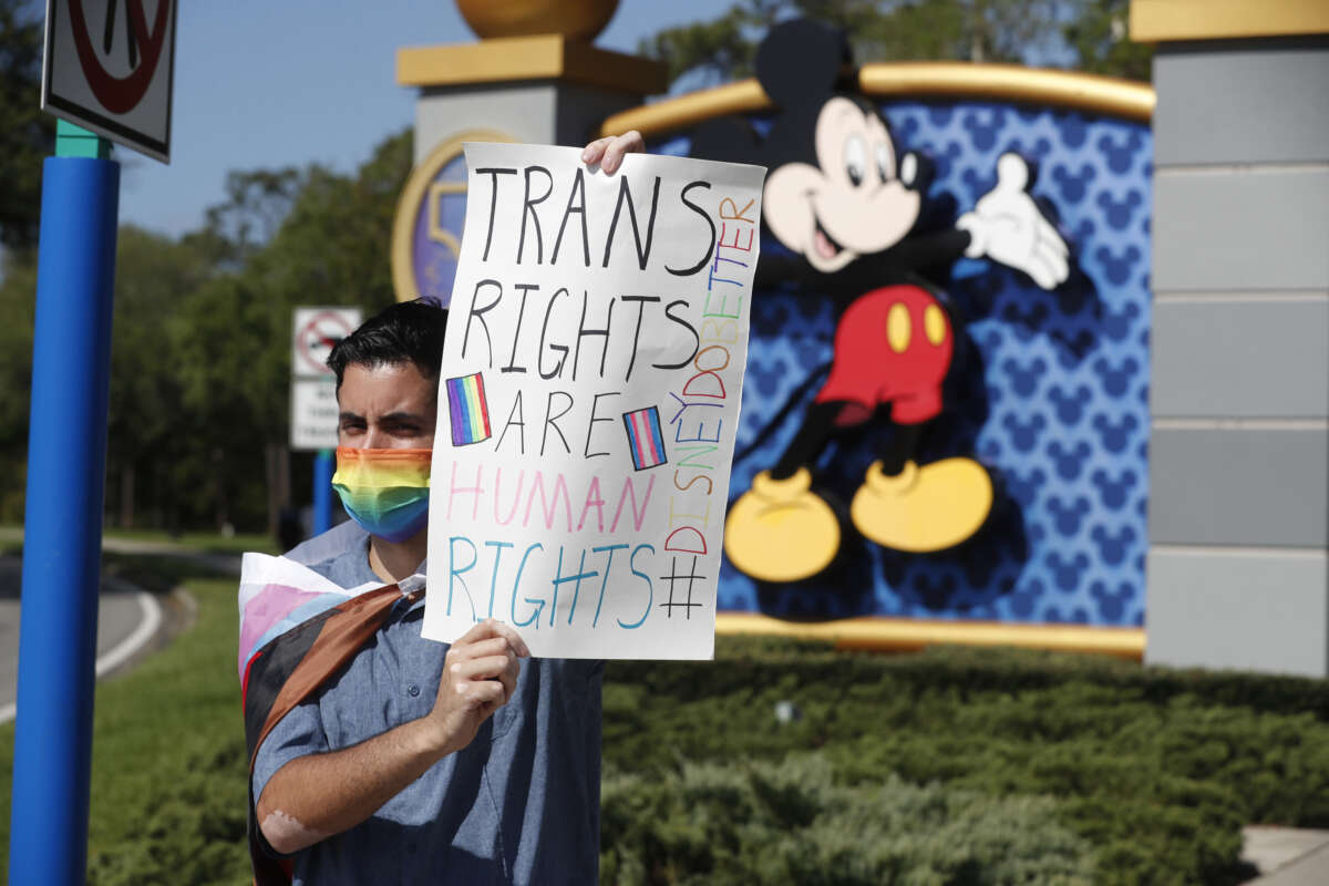 Disney employee Nicholas Maldonado holds a sign while protesting outside of Walt Disney World on March 22, 2022, in Orlando, Florida. Employees staged a company-wide walkout to protest Walt Disney Co.'s response to legislation passed in Florida known as the “Don’t Say Gay” bill.