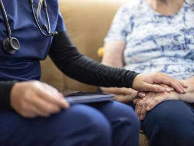 An elderly woman and a nurse
